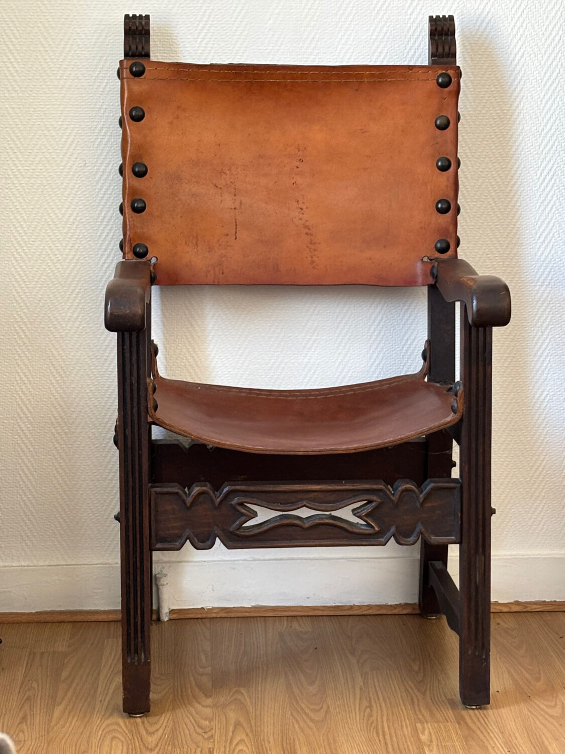 Frailero armchair, antique Spanish — carved wood & full-grain leather.