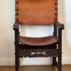Frailero armchair, antique Spanish — carved wood & full-grain leather.