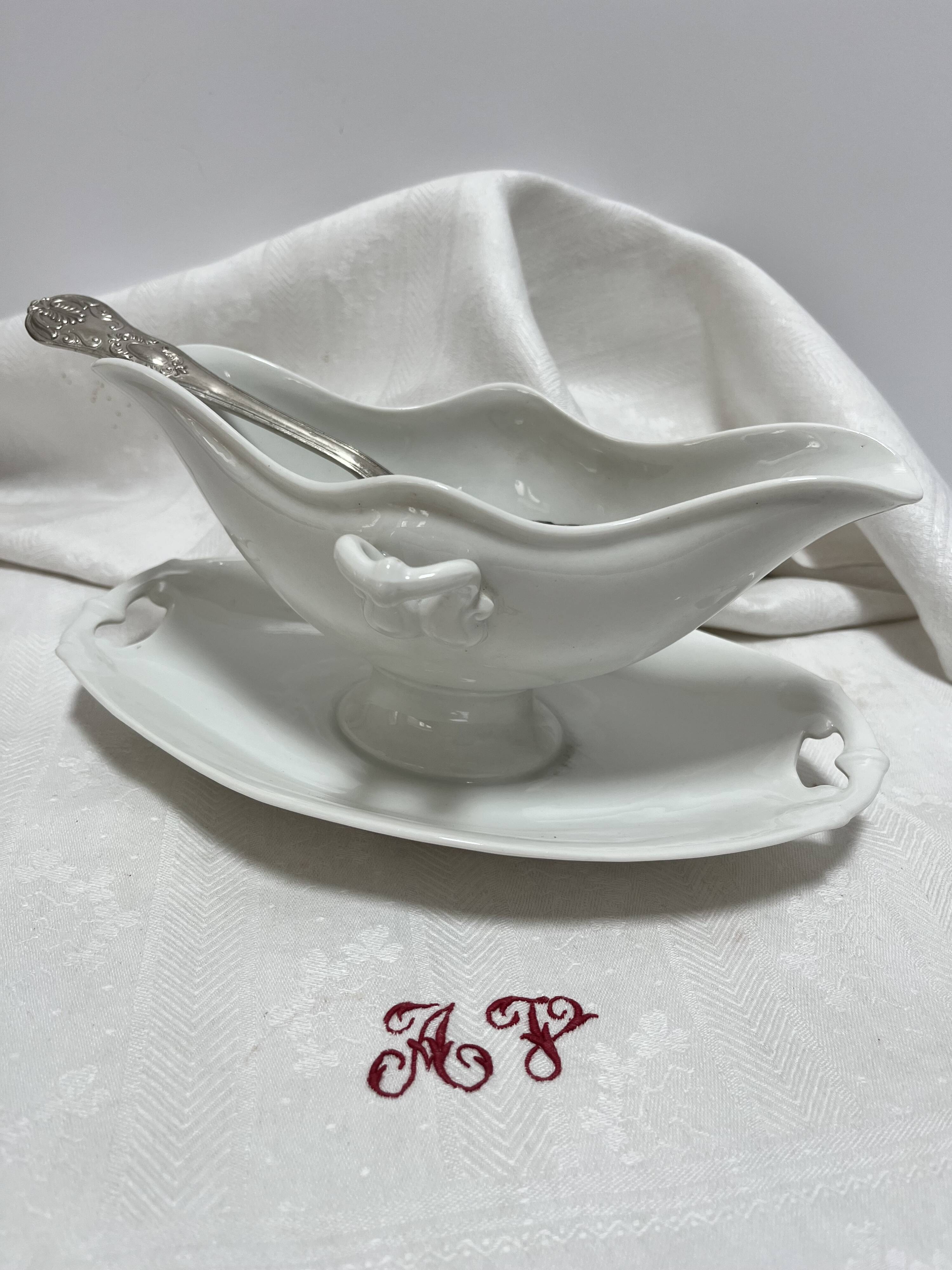 White porcelain sauce boat on tray