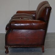 Restored Victorian sofa in leather with claw feet and feather cushions.