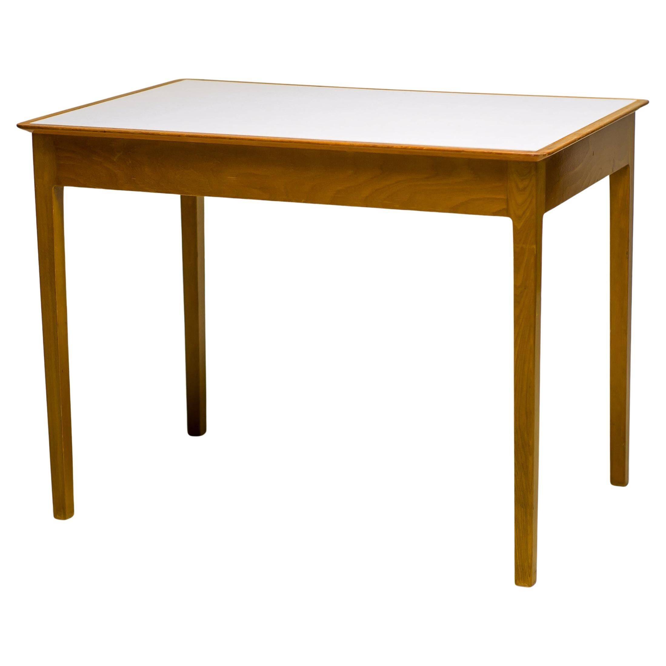 Small maple desk with a laminate top and two drawers, Fritz Hansen, 1950s.