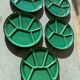 Many glazed stoneware plates with compartments.