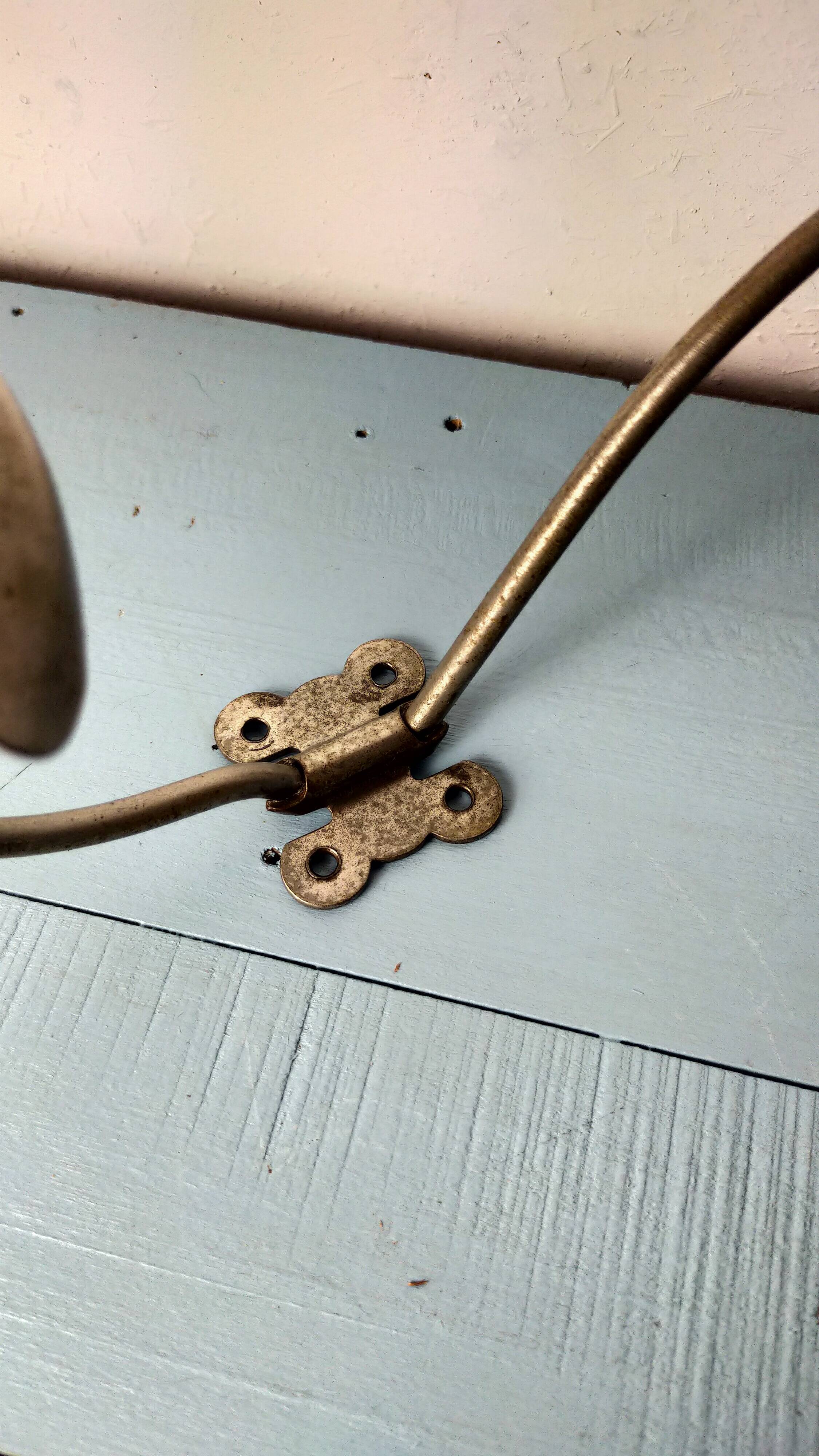 Antique coat rack with red wooden ball