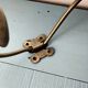 Antique coat rack with red wooden ball