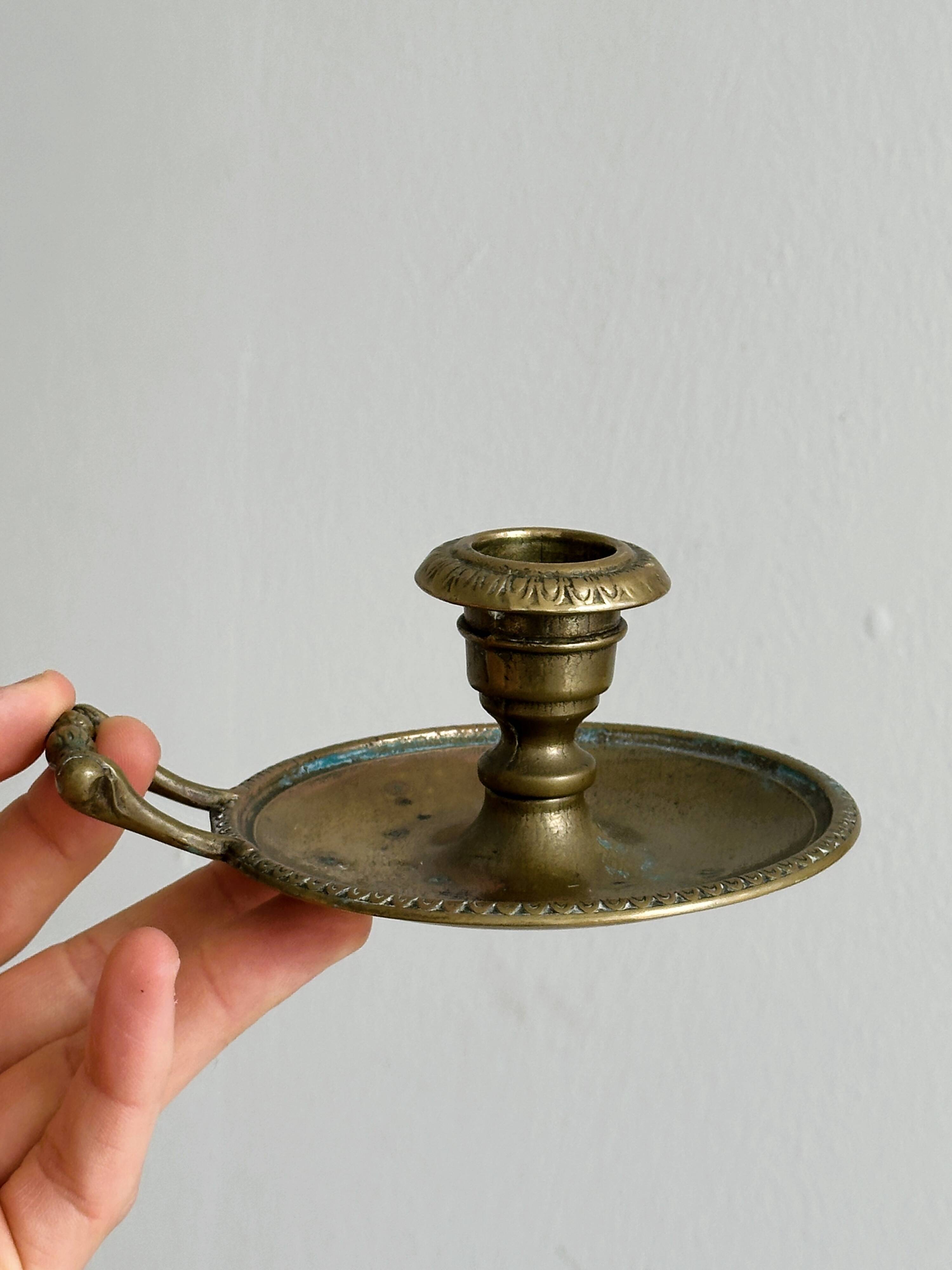 Brass candle holder with handle.