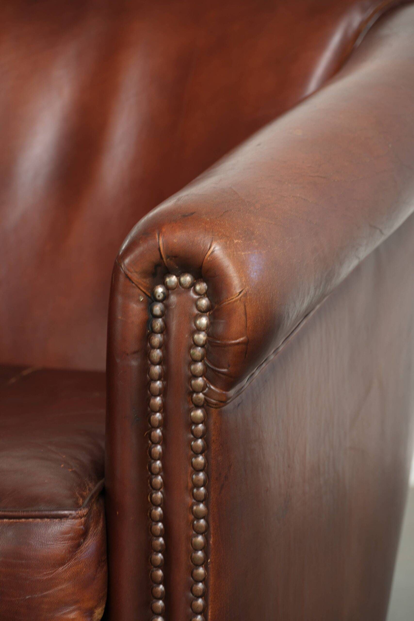 Sheepskin club armchair in English style with brown colour scheme