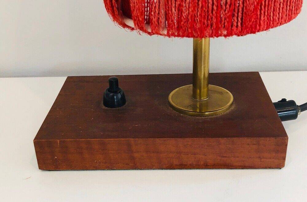 Small lamp made of wood, brass, and wool.