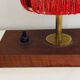Small lamp made of wood, brass, and wool.