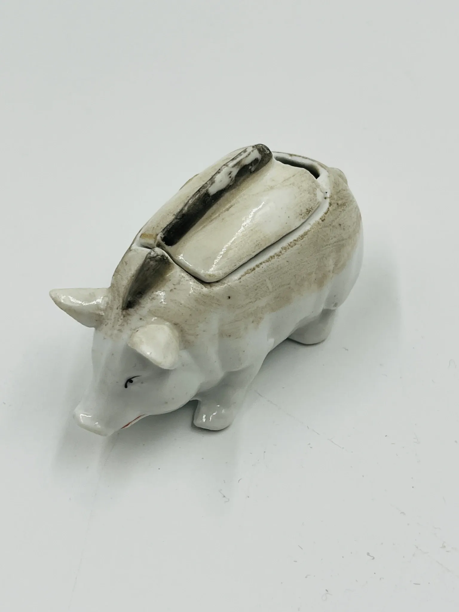 Vintage mustard pot in porcelain shaped like a pig.