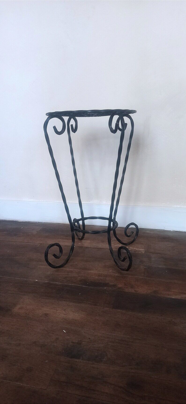 Black wrought iron support for plants
