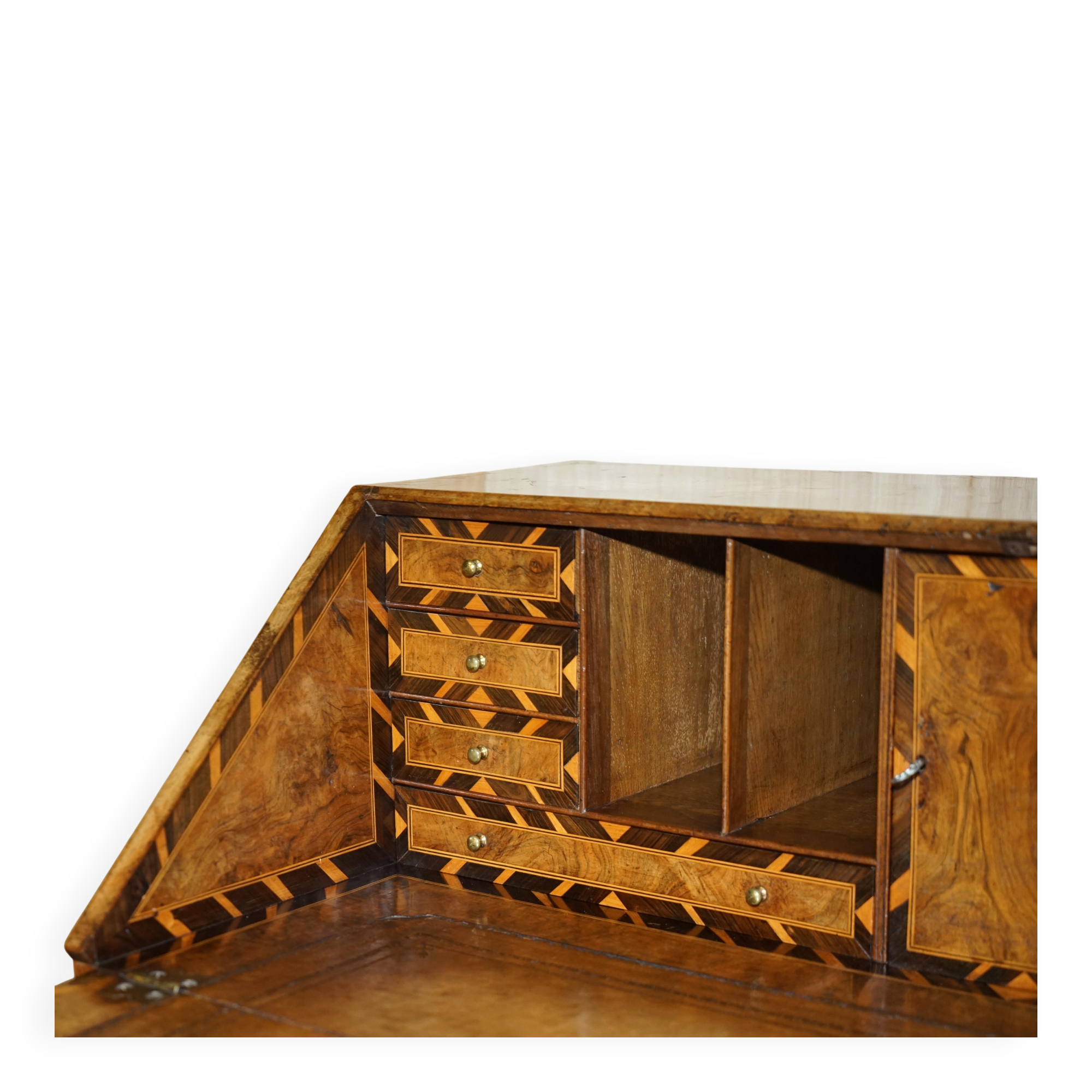 Antique George II bureau from 1740 in walnut, rosewood, and leather.