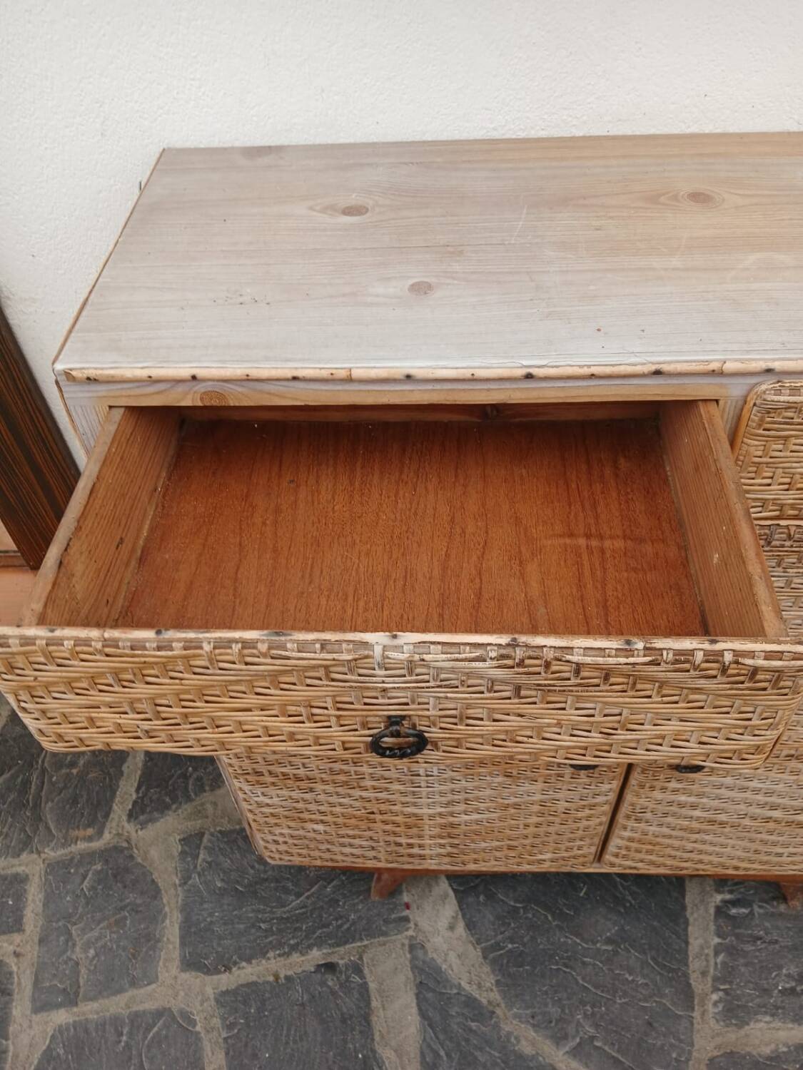 Vintage woven rattan furniture with tapered legs.