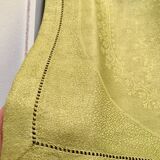 Old embroidered green square table napkin with cutwork