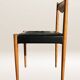 Set of 6 modernist chairs with black faux leather seats.