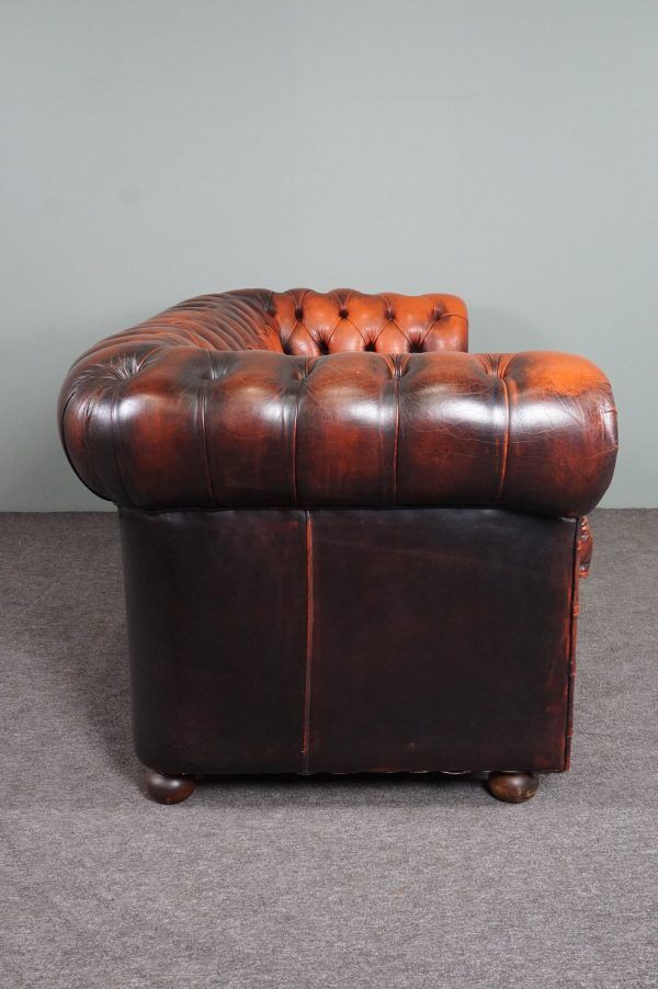 Chesterfield sofa in patinated orange leather, 2.5 seats