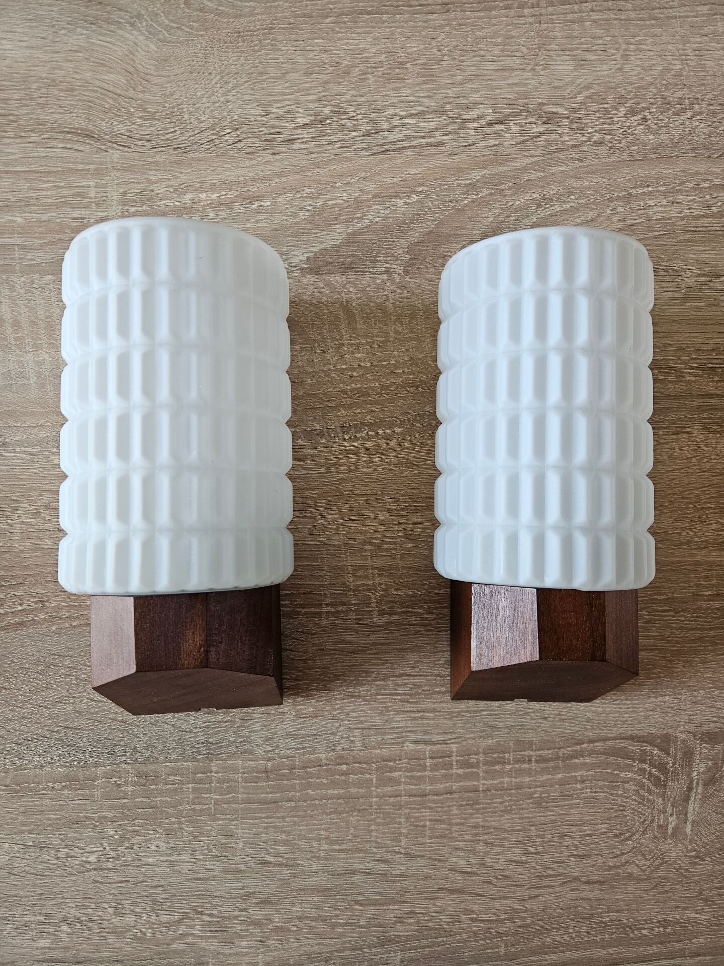 Philips wall sconces in wood and white opal.
