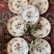 7 hand-painted flowered dinner plates.