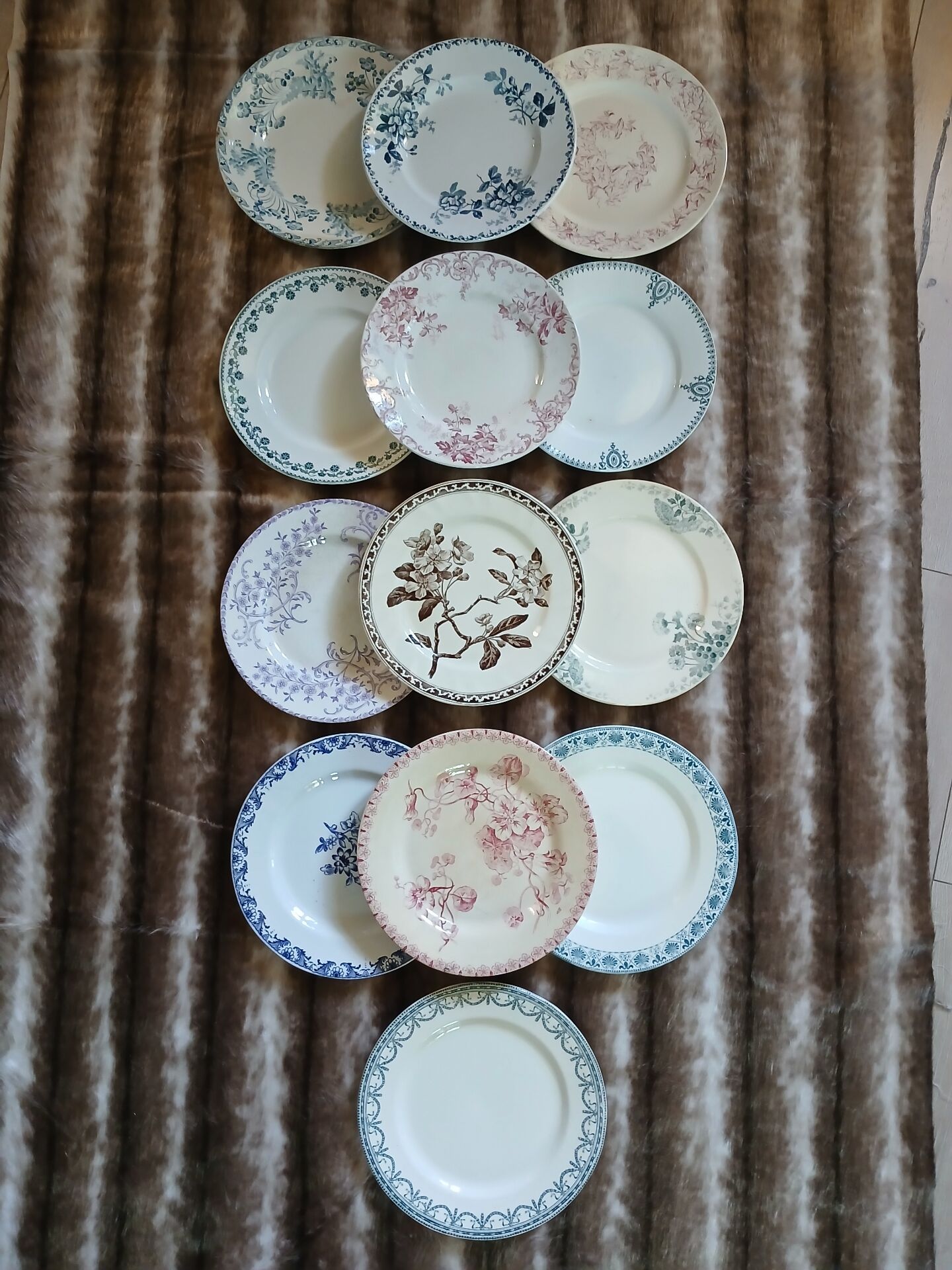 13 mismatched flat plates in ironstone