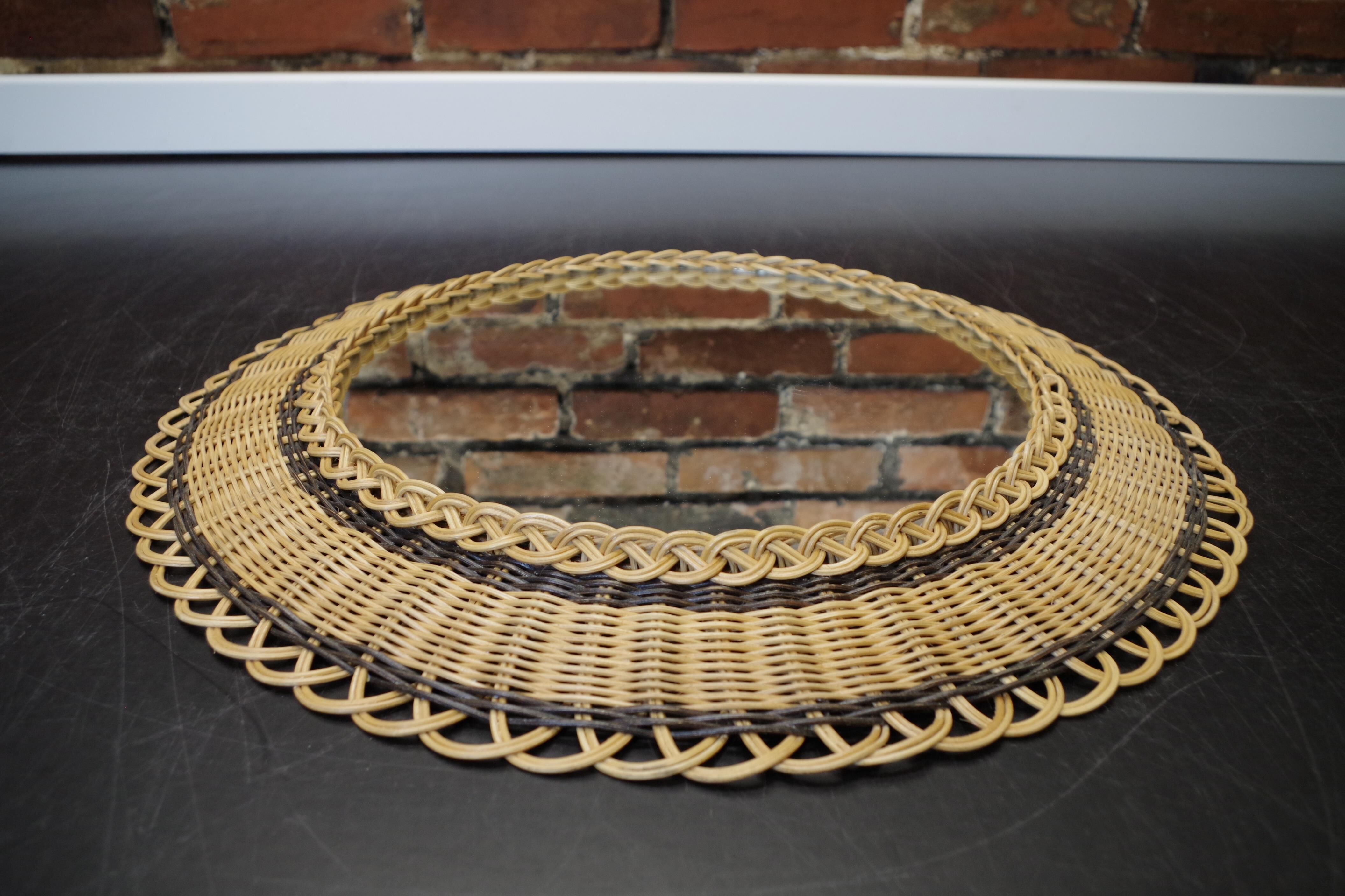 Vintage round mirror in a wicker frame