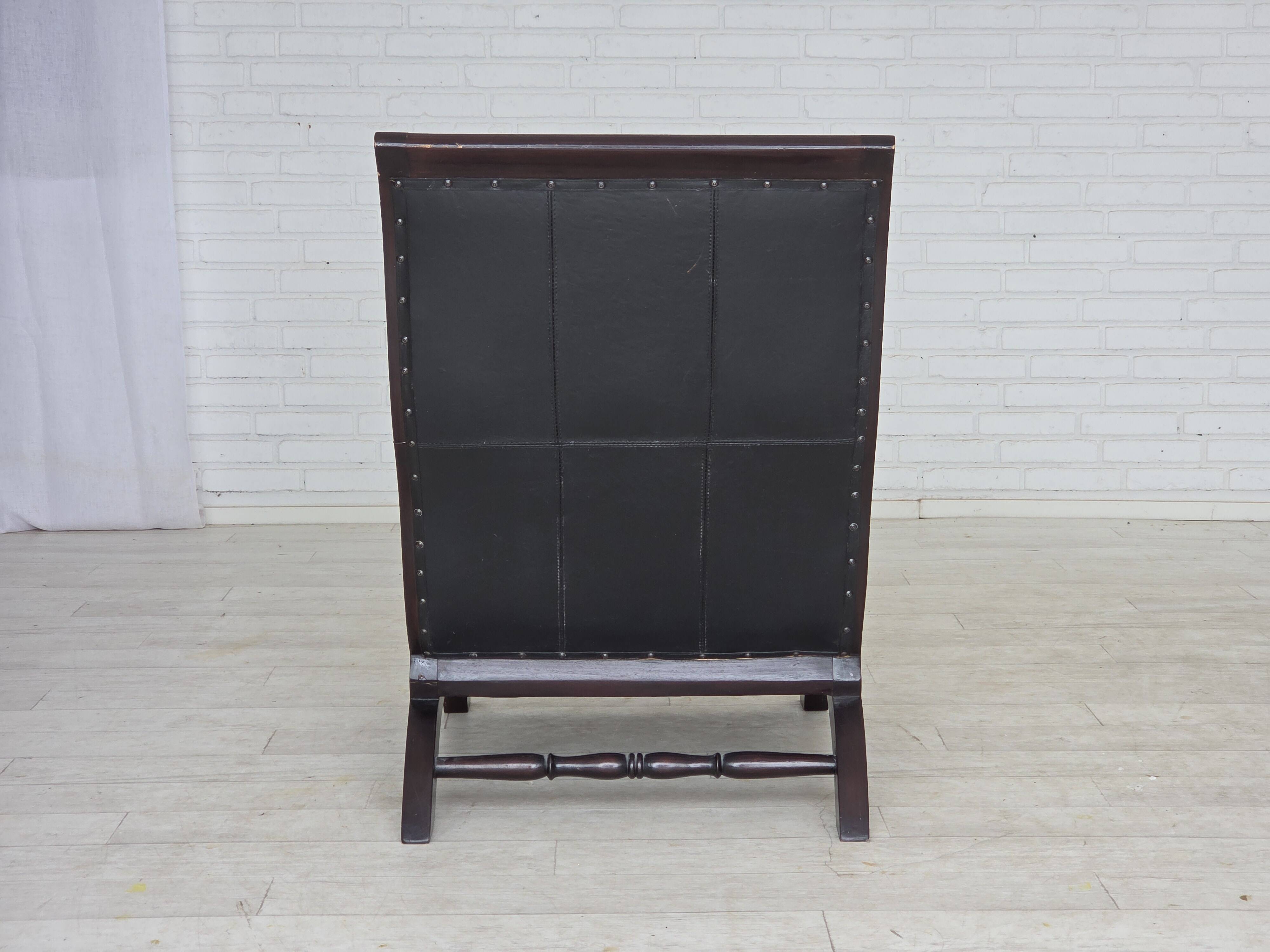 1970s, vintage armchair with footstool, black furniture leather.