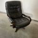 Scandinavian swivel lounge chair in black leather with a bent wood frame, 1970s.