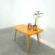 Vintage veneer table with pretty angular legs and brass at the base of the legs.