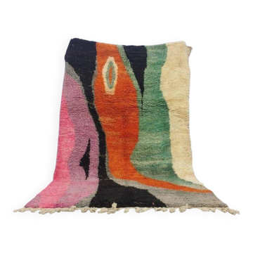 Large handmade Moroccan rug with colourful patterns.