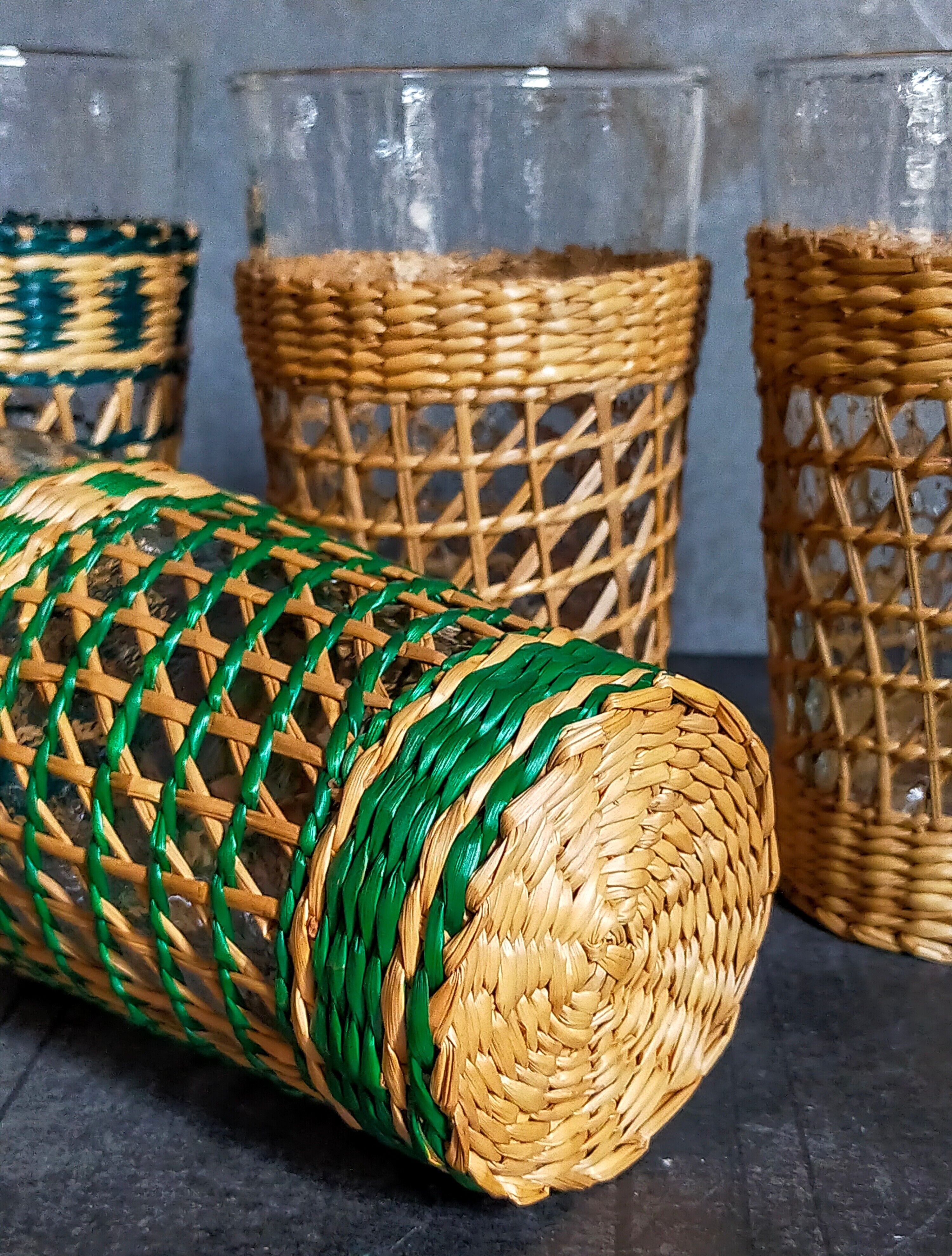Four long drink glasses in vintage woven rattan cases