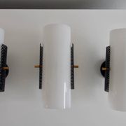 Set of four wall lights in white plexiglass and perforated black metal.