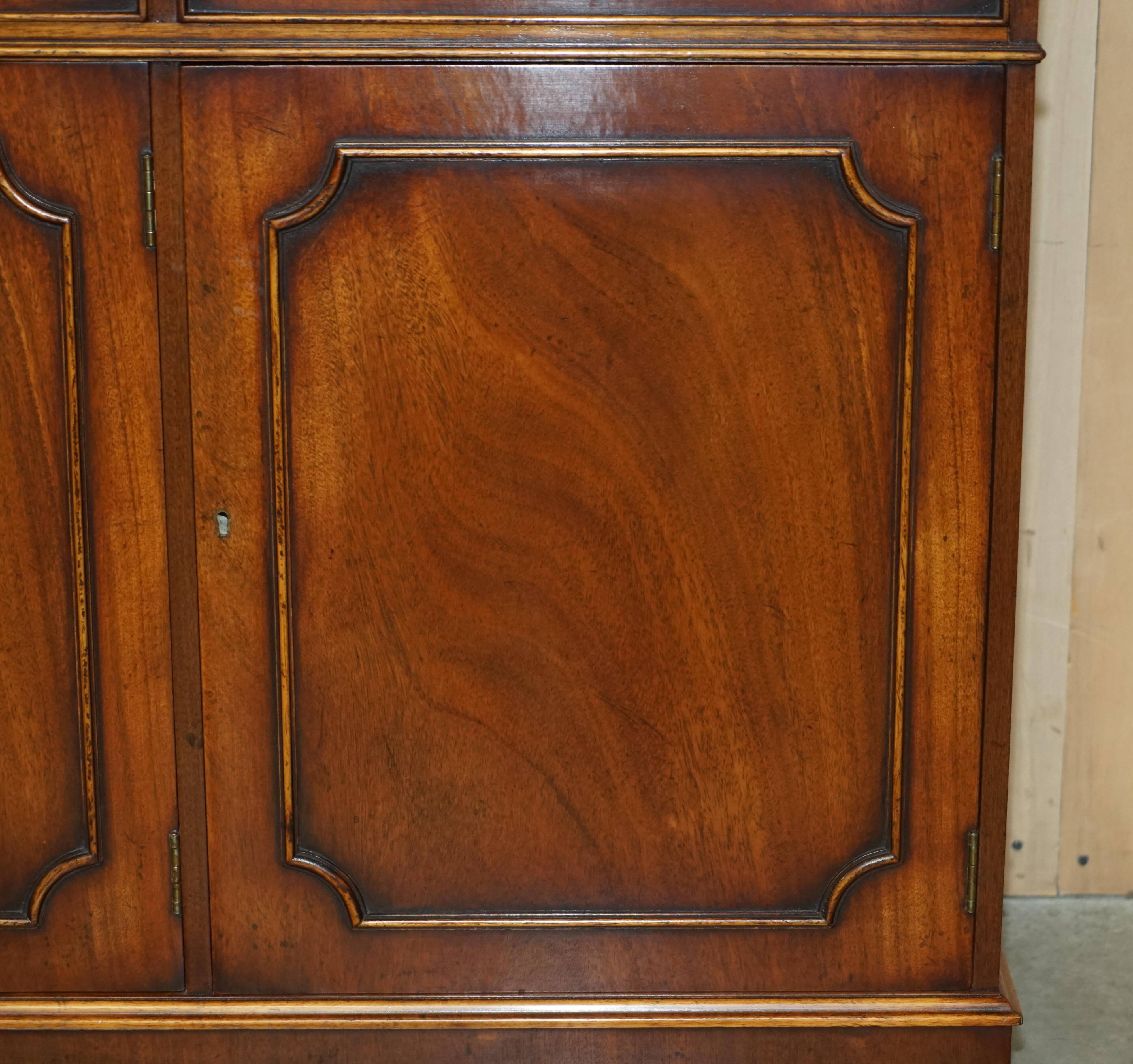 Vintage mahogany buffet with three drawers and shelves.