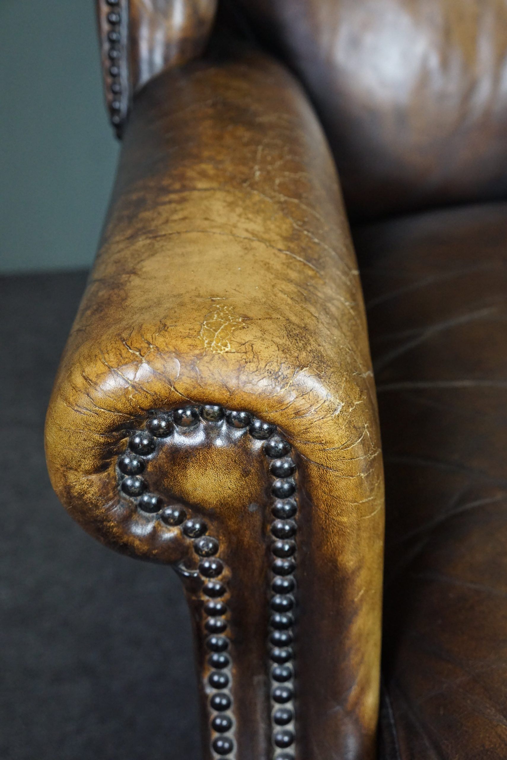 Patinated cowhide leather armchair