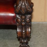 Victorian Chesterfield leather sofa with carved lion heads.