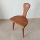 Low brutalist tripod chair in solid oak from the 1960s.