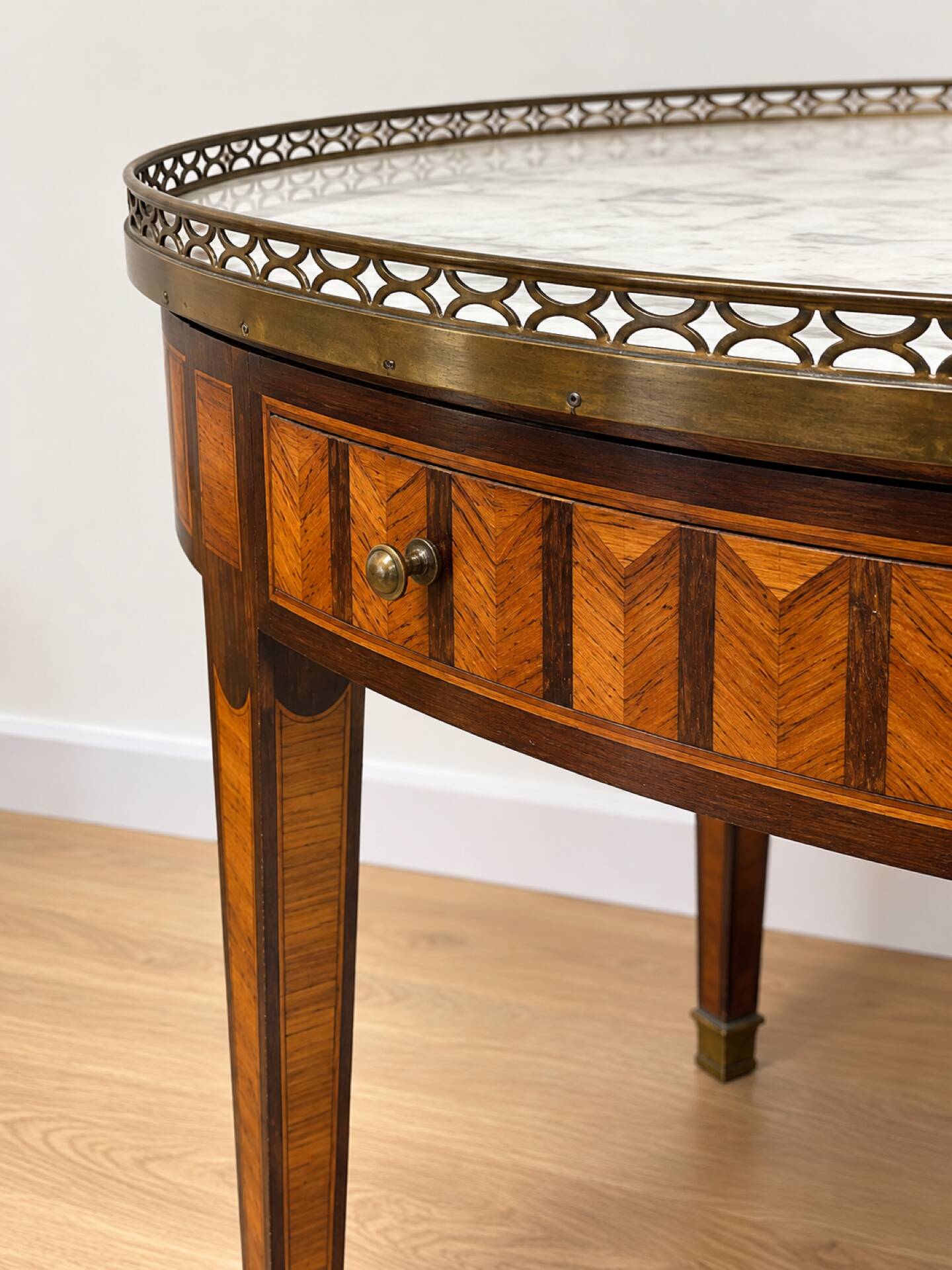 Bouillotte table in Louis XVI style with marquetry, marble, and brass.