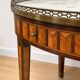 Bouillotte table in Louis XVI style with marquetry, marble, and brass.