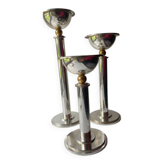 Trio of silver metal candlesticks