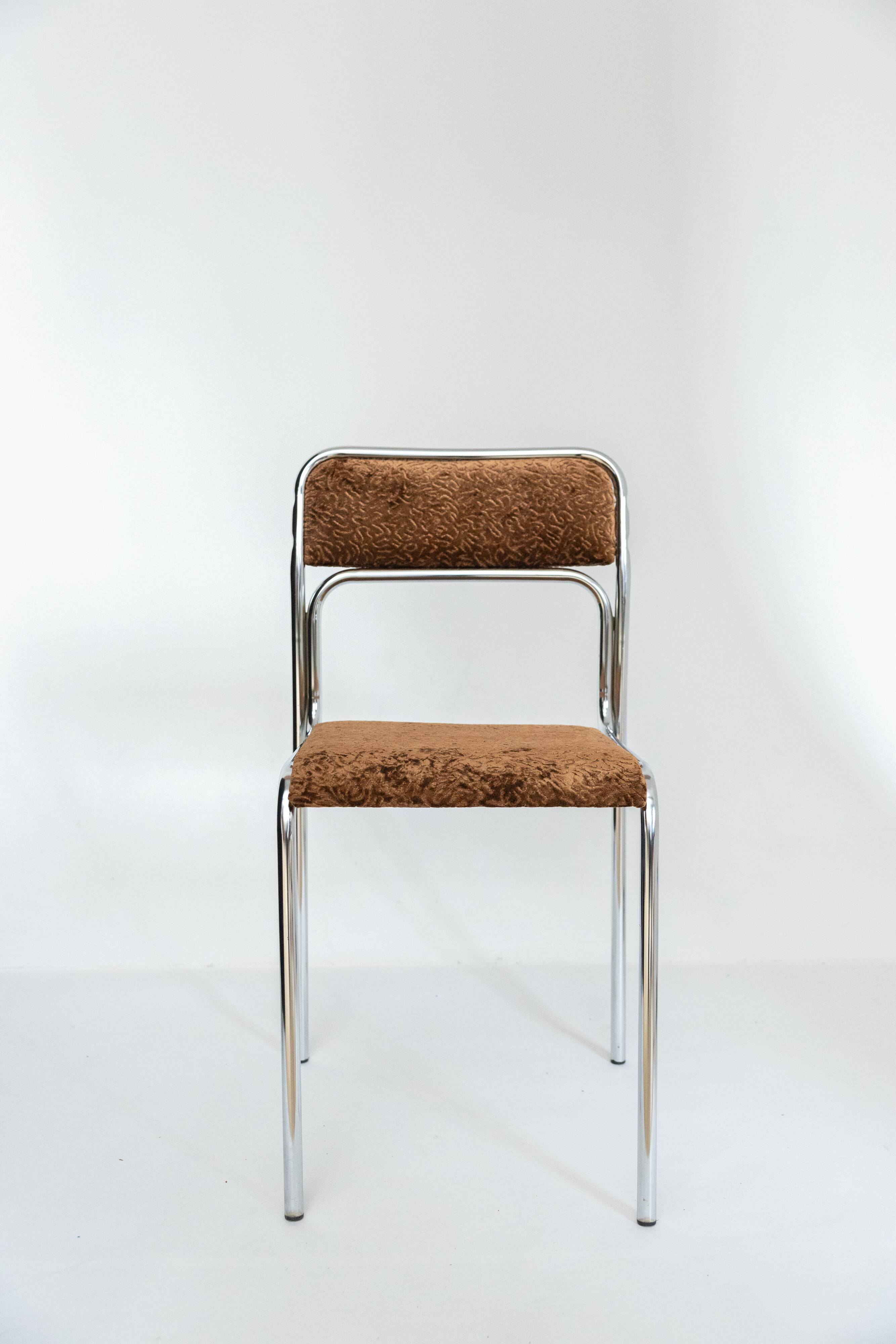 Chrome dining chair upholstered in brown bitten velvet.