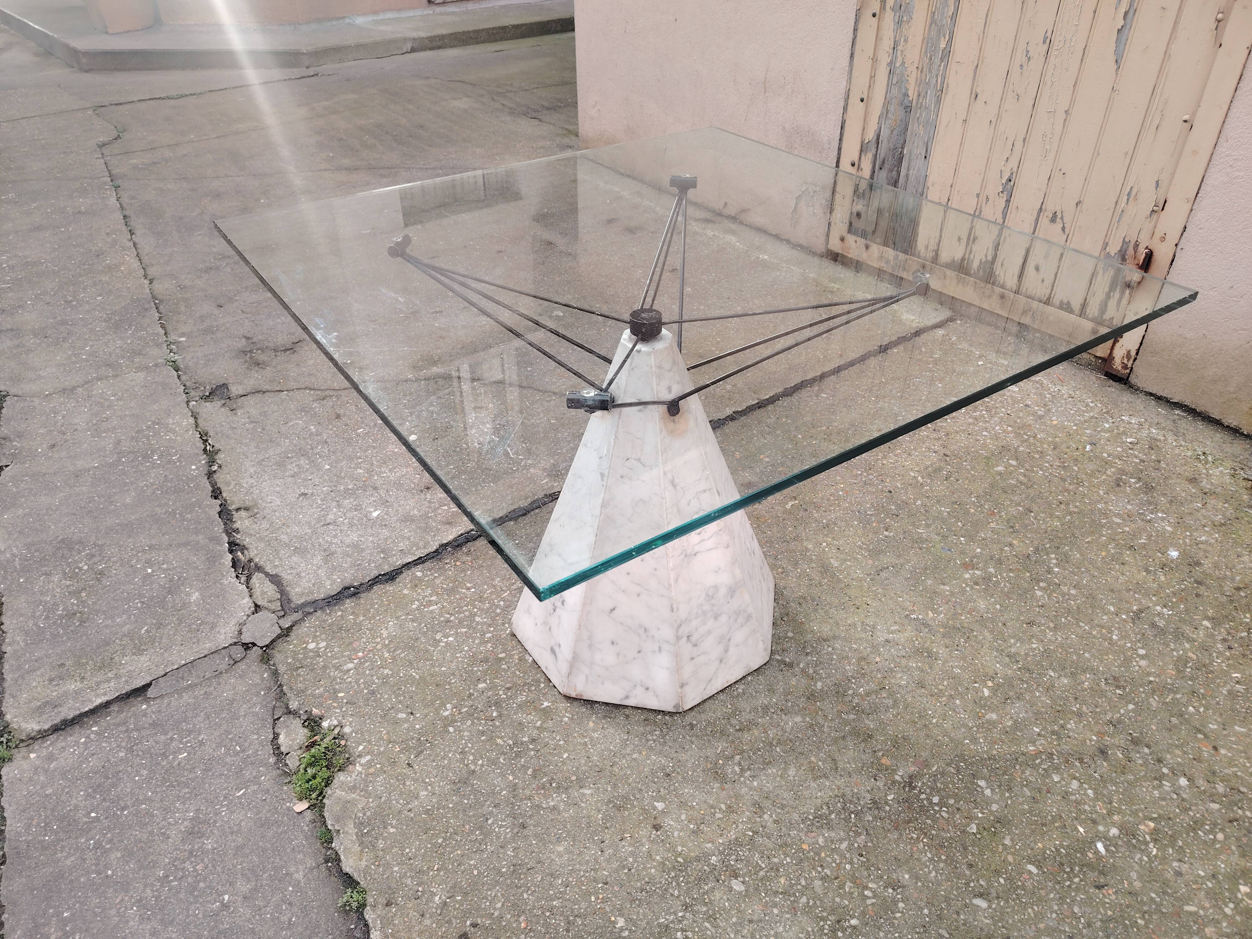 1980s table with a marble and steel base and a square glass top.