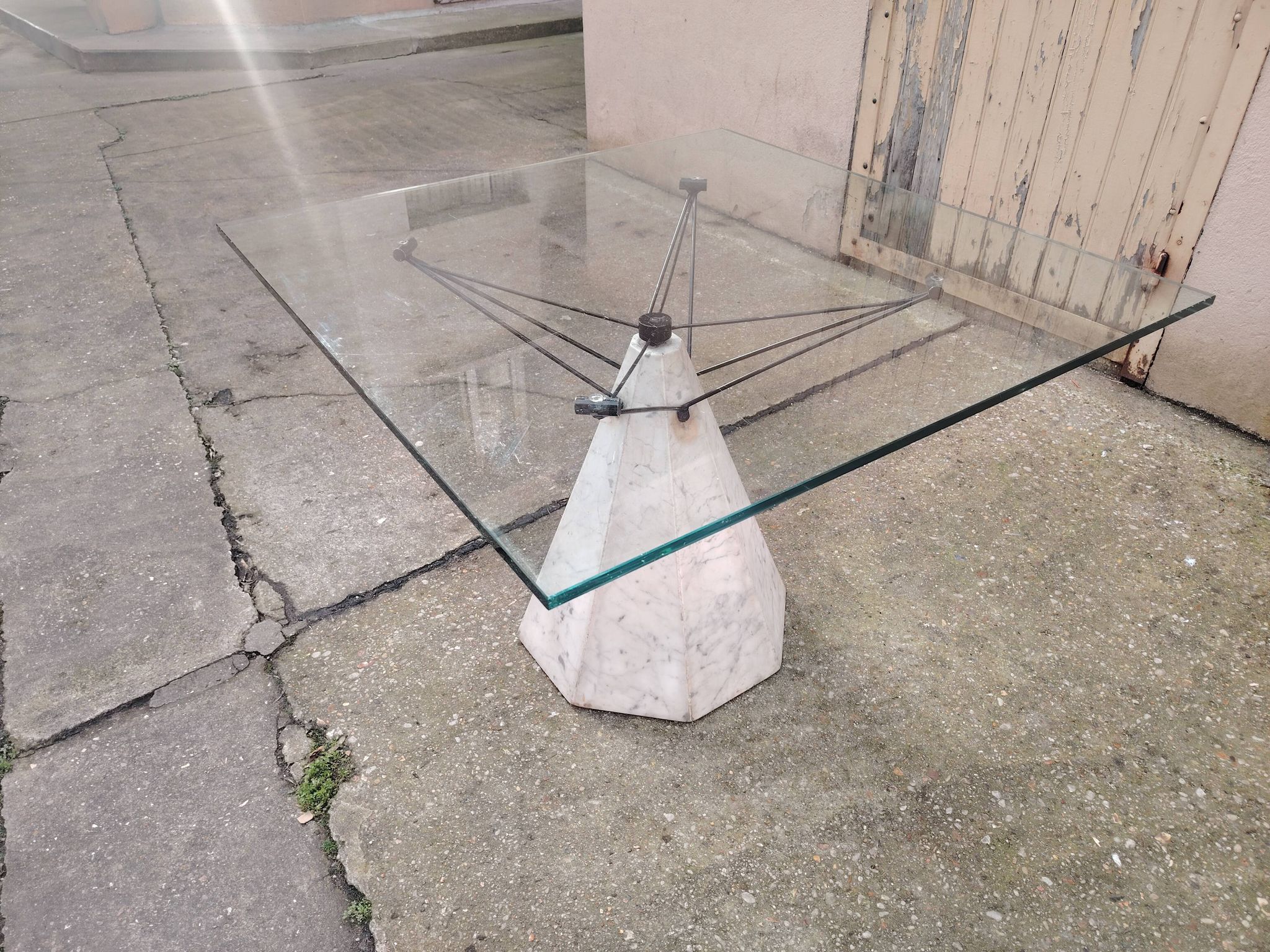 1980s table with a marble and steel base and a square glass top.