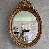 Oval mirror in carved and gilded wood in Louis XVI style