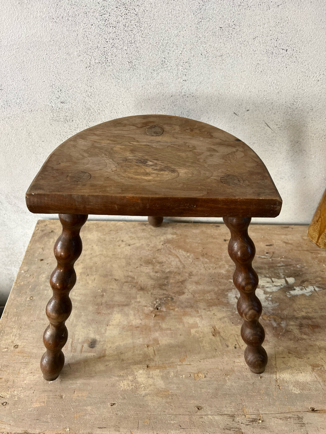 Wooden tripod farm stool