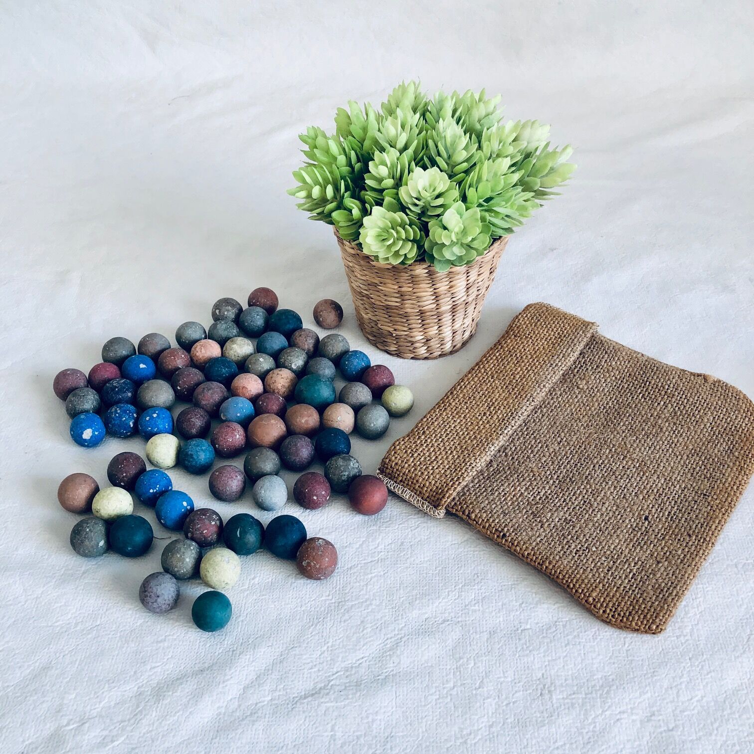 70 clay marbles and burlap bag