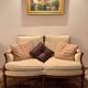 Two-seater canapé by Roche Bobois in Louis XVI style — carved wood, caned sides.