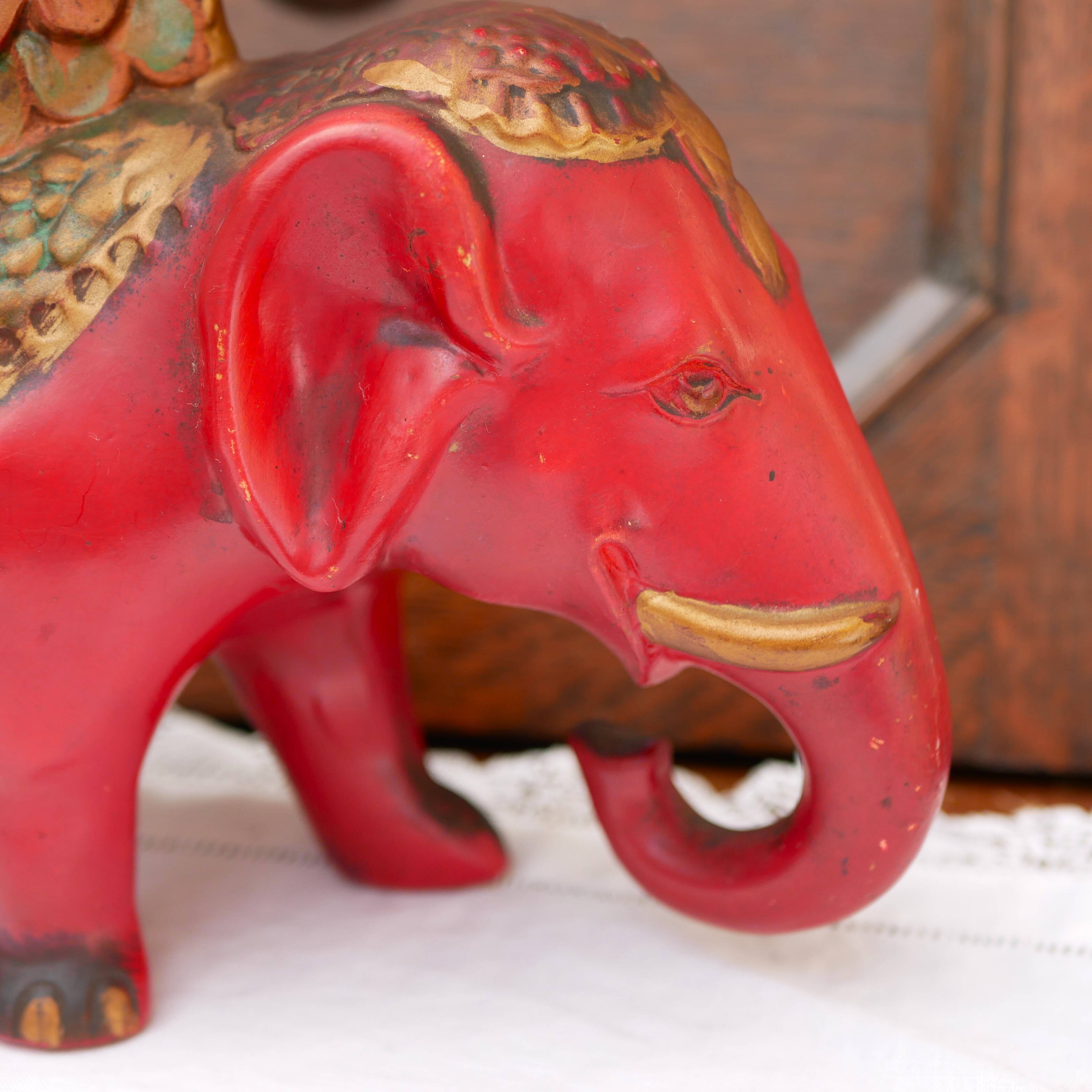 A pair of red and gold ceramic vases in the shape of elephants, 1940s.