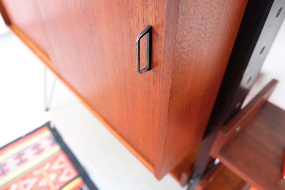 Vintage teak shelving system in 60s-70s style, retro style.