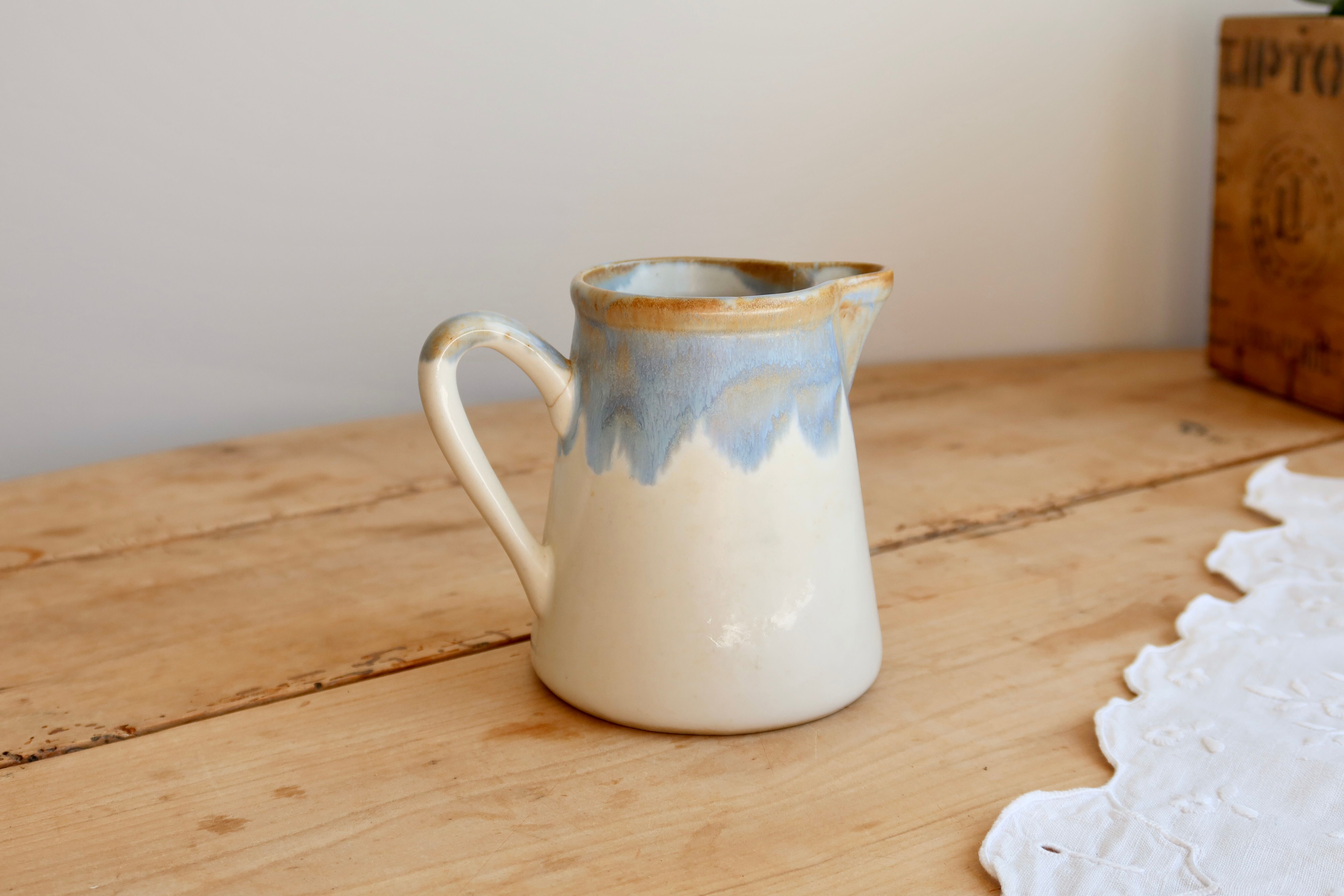 Vintage ceramic milk jug with a blue and taupe gradient glaze.