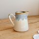 Vintage ceramic milk jug with a blue and taupe gradient glaze.