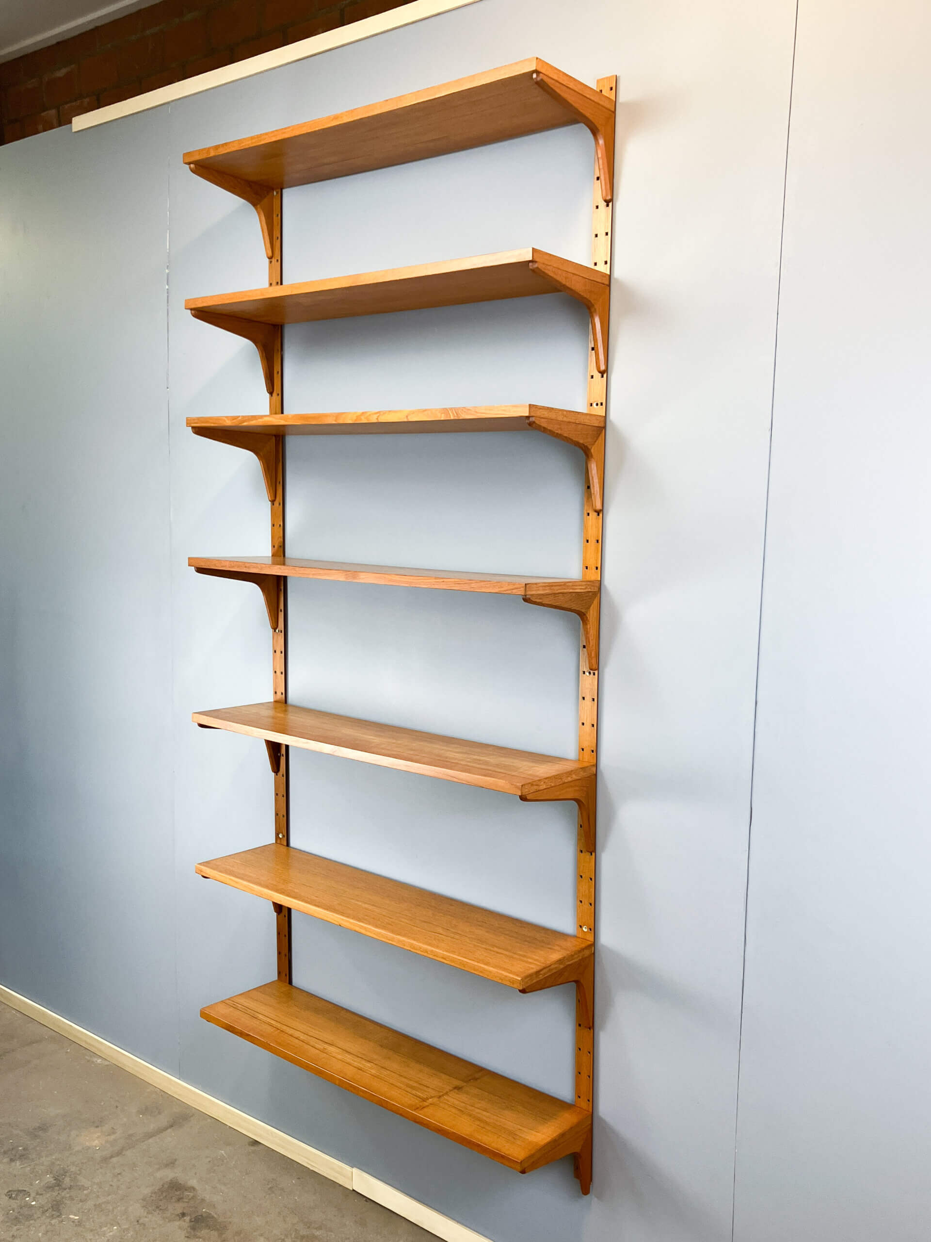 Danish wall shelf by Hansen and Guldborg, teak, aluminum rails, 1960s.