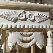 Carved wooden stool with a white patina.