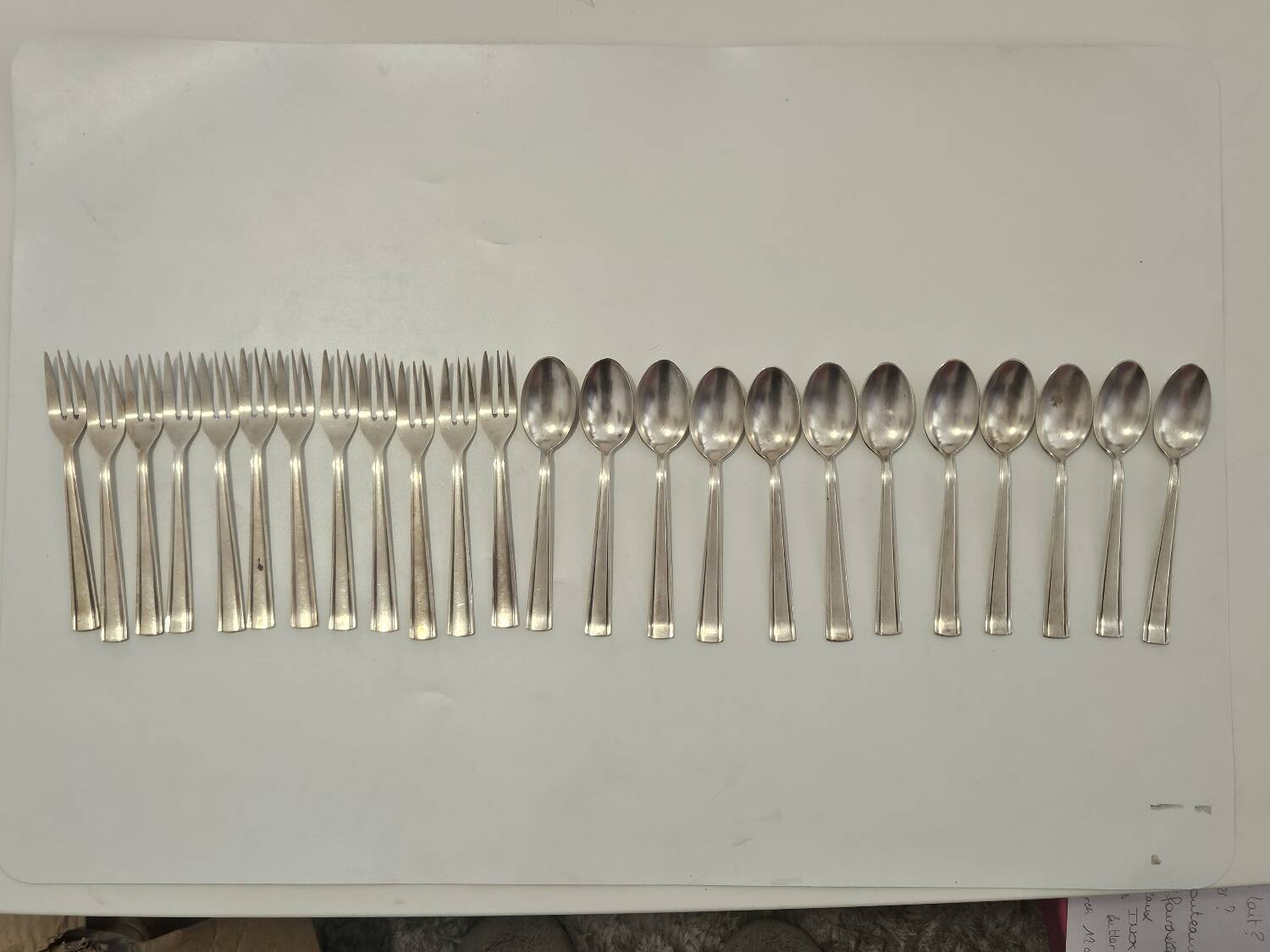 Set of silver dessert spoons and forks